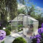 KGT Gewächshaus Orchidee Alu blank, 9,59 m², mit geöffneter Tür im Garten.