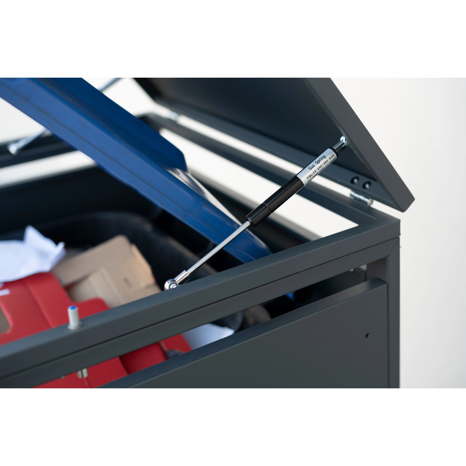 Geöffnete anthrazitfarbene Westmann Mülltonnenbox Kubus mit Gasdruckfeder. 