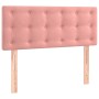 Rosa Boxspringbett Kopfteil aus Samt mit Knopfheftung und Holzfüßen.