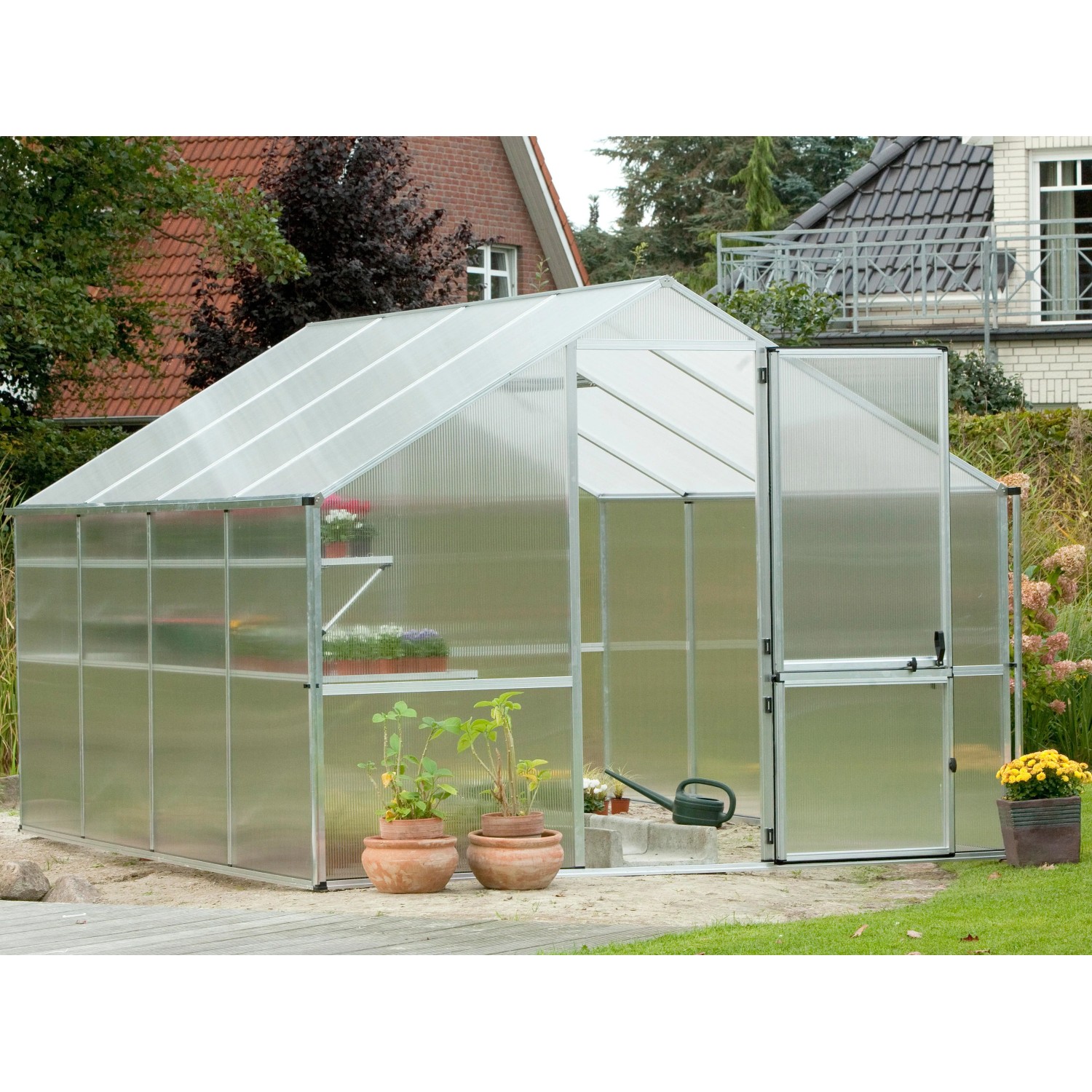 KGT Gewächshaus Orchidee, 12,74 m², Alu blank, mit geöffneter Tür und Pflanzen.