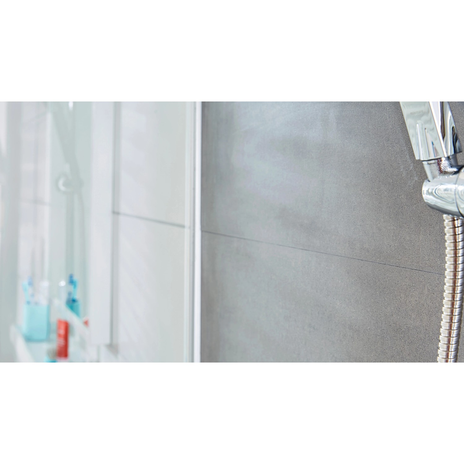 Tesa Powerstrips Haken Waterproof Edelstahl Large im Badezimmer an grauer Wand.