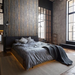 Anthrazitfarbene Marburg Vliestapete mit Marmor- und Putzoptik im Schlafzimmer.