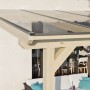 Skan Holz Terrassenüberdachung Andria mit klarer Polycarbonat-Eindeckung und unbehandeltem Leimholz.