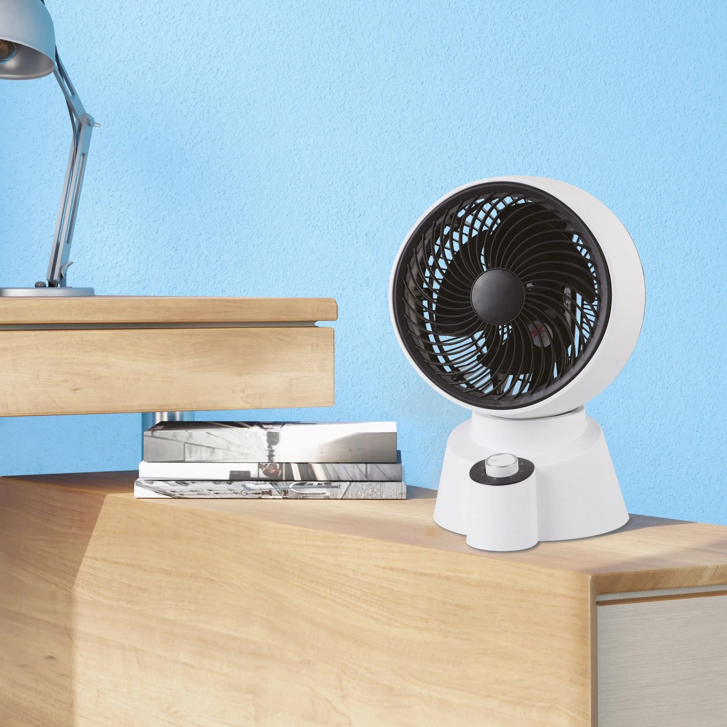 Weißer Tischventilator (50 W) mit schwarzem Rotorblatt auf einem Tisch. Kategorie: Ventilatoren.