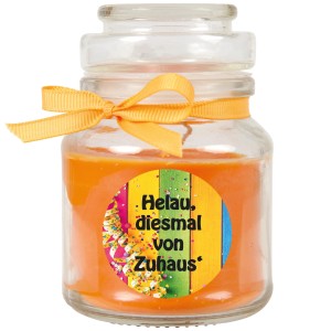 Orangefarbene Duftkerze im Glas mit Karnevalsmotiv und Schleife, 30h Brenndauer.