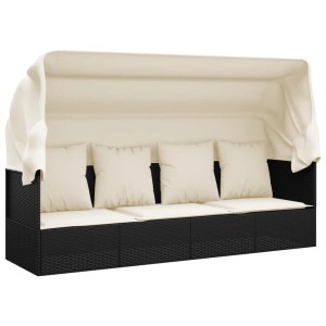 Schwarzes Outdoor-Loungebett mit Dach und cremefarbenen Kissen aus Poly Rattan.