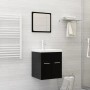 Modernes weißes Keramik Einbauwaschbecken mit Chrom-Wasserhahn auf schwarzem Unterschrank im Badezimmer.