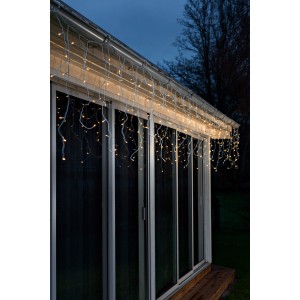 LED Lichtervorhang Eisregen mit 200 bernsteinfarbenen LEDs für den Außenbereich am Hausgiebel.