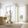 Wohnzimmer mit weißem Gardinia Erkerbogen GE2 für 2-läufige Gardinenschienen.