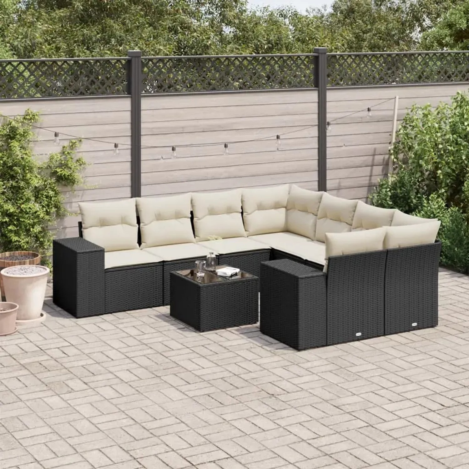 Schwarze 9-tlg. Garten-Sofagarnitur aus Polyrattan mit cremefarbenen Kissen und Tisch für Terrasse oder Garten.