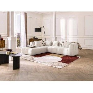 Beiges Vente-unique Naemia Ecksofa (263 cm) mit Kissen in einem hellen Wohnzimmer auf Teppich.