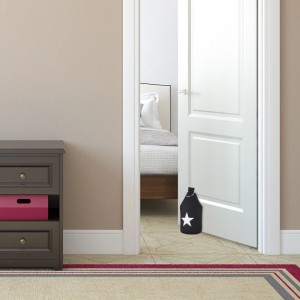 Schwarzer Relaxdays Türstopper mit Stern-Motiv aus Baumwolle und Metallgriff vor weißer Tür.