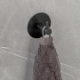 Schwarzer Schöner Wohnen Wandhaken Uno Meleto mit Handtuch an grauer Wand.