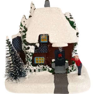 Beleuchtetes Weihnachtsdorf mit schneebedecktem Haus, Tanne und Kind. Stimmungsvolle Weihnachtsdekoration aus Kunststoff.