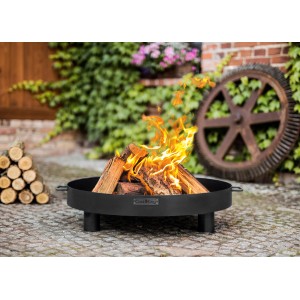 Schwarze CookKing Feuerschale Tunis Ø 60cm mit brennendem Holz im Garten.