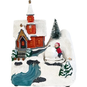 Beleuchtetes Weihnachtsdorf mit roter Kirche, Schnee und Figur, die Schneemann baut. Mehrfarbige Weihnachtsdekoration.