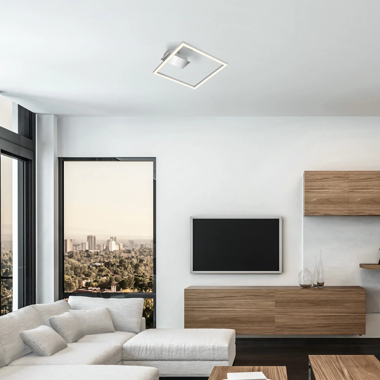 Moderne, silberne Brilo LED-Deckenleuchte Nici mit warmweißem Licht in Wohnraum.