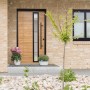 Splendoor Haustür ThermoSpace Paris Prime in Eiche Natur mit schwarzem Rahmen und Glasausschnitt.