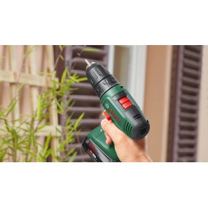 Hand hält Bosch 18V Akku-Bohrschrauber EasyDrill 18V-40. Grüner Akkuschrauber mit schwarzem Griff und rotem Schalter.