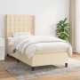 Cremefarbenes Boxspringbett (90x200 cm) mit Matratze und hohem Kopfteil. Stoffbezug.