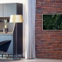 Könighaus Infrarotheizung Panorama mit Waldmotiv an Ziegelwand im Wohnraum.