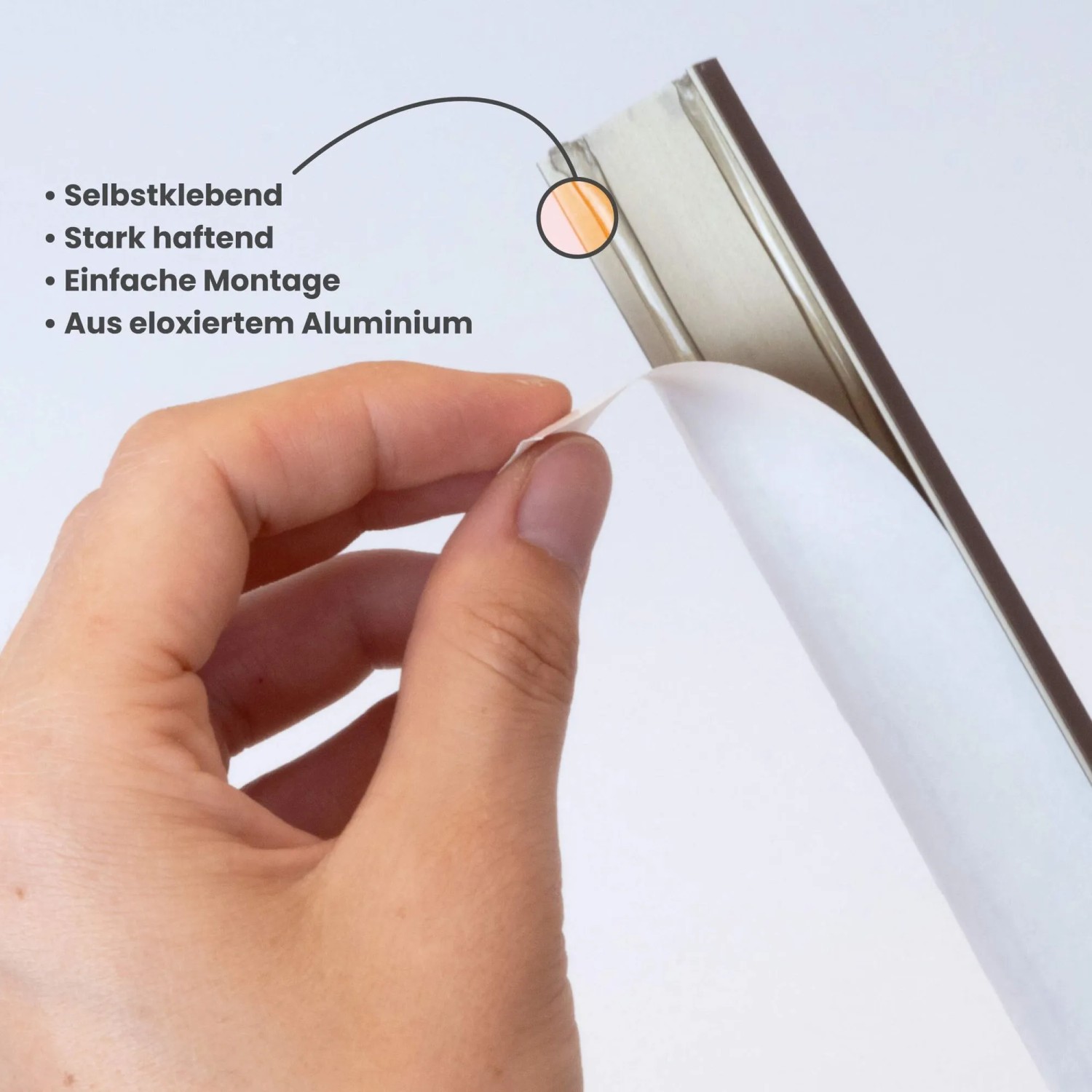 Hand zieht Schutzfolie von selbstklebendem Dalsys Treppenkantenprofil ab. Einfache Montage des Aluminiumprofils.