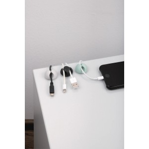 Fix-o-moll Kabelfixierer in Mehrfarbig mit Kabeln an einem Tisch befestigt.