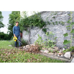 Mann benutzt gelben Kärcher Akku-Laubbläser LBL 2 Battery im Garten, um Laub zu entfernen.