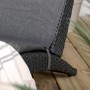 Detailansicht: Schwarze ebuy24 Archie Sonnenliege aus Rattan mit grauem Kissen.