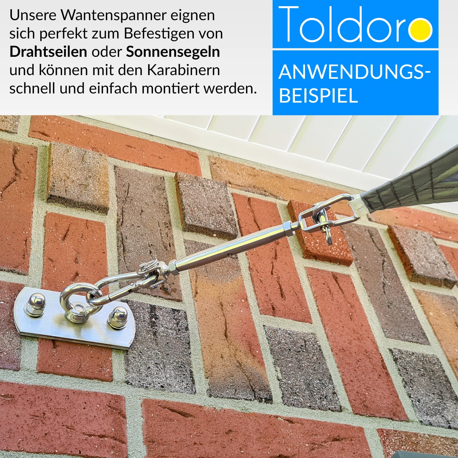 Toldoro Sonnensegelspanner mit Karabiner an einer Backsteinwand befestigt.