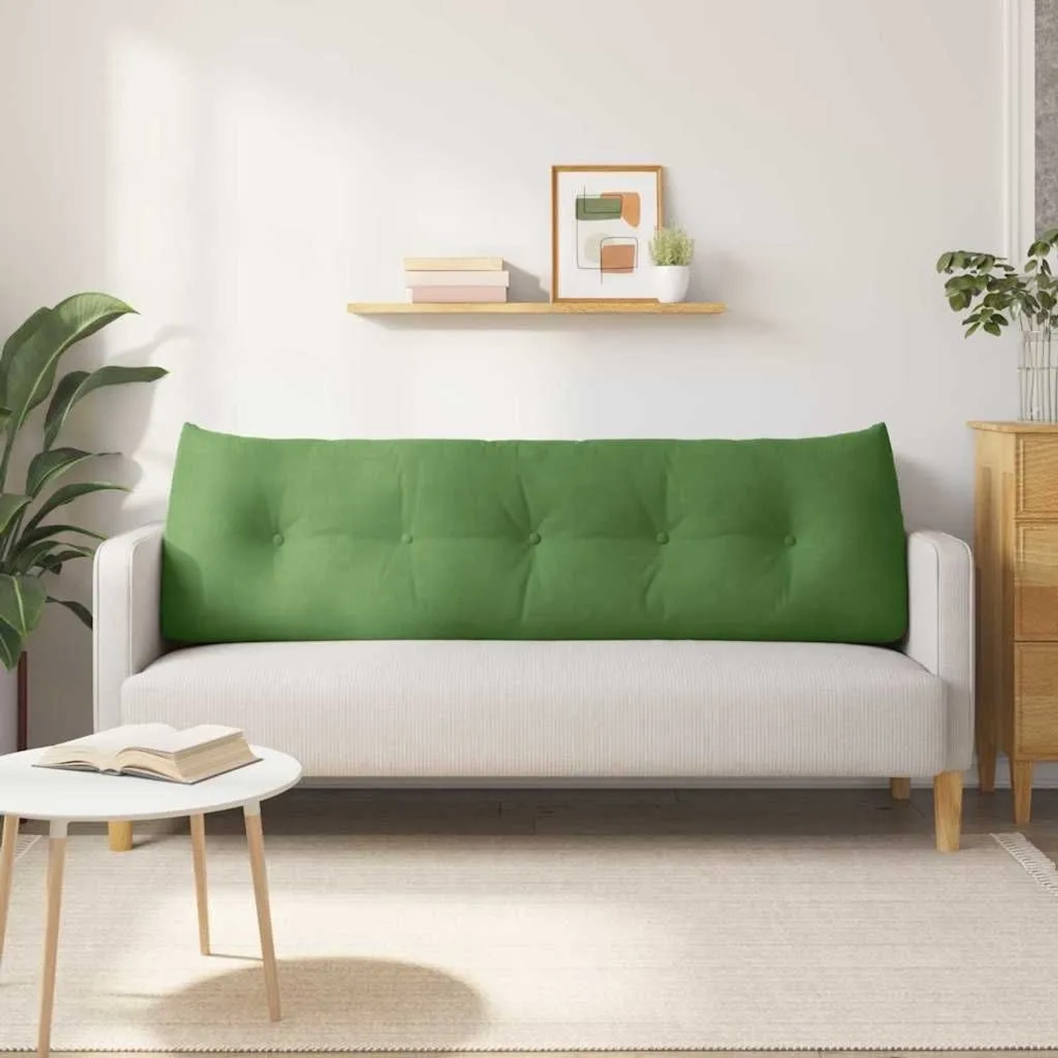 Hellgrünes Samt-Rückenkissen mit Knopfheftung auf hellem Sofa. Ergonomisches Kissen für Komfort im Wohnzimmer.