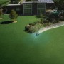 Segway Navimow X420E AWD Mähroboter bei der Arbeit auf einer Rasenfläche vor einem modernen Haus.