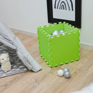 Grüne LittleTom Puzzlematte, 9 Teile als Würfel aufgebaut, mit Spielbällen, neben Tipi.