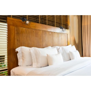 Schwarze Globo Klemmleuchte Xara I mit Metallgeflecht am Bett befestigt.