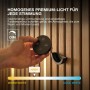 Hand dimmt OSRAM Acoustic LED Streifen an Holzpaneelen mit schwarzer Fernbedienung. Zeigt Farbtemperatur Warmweiß.