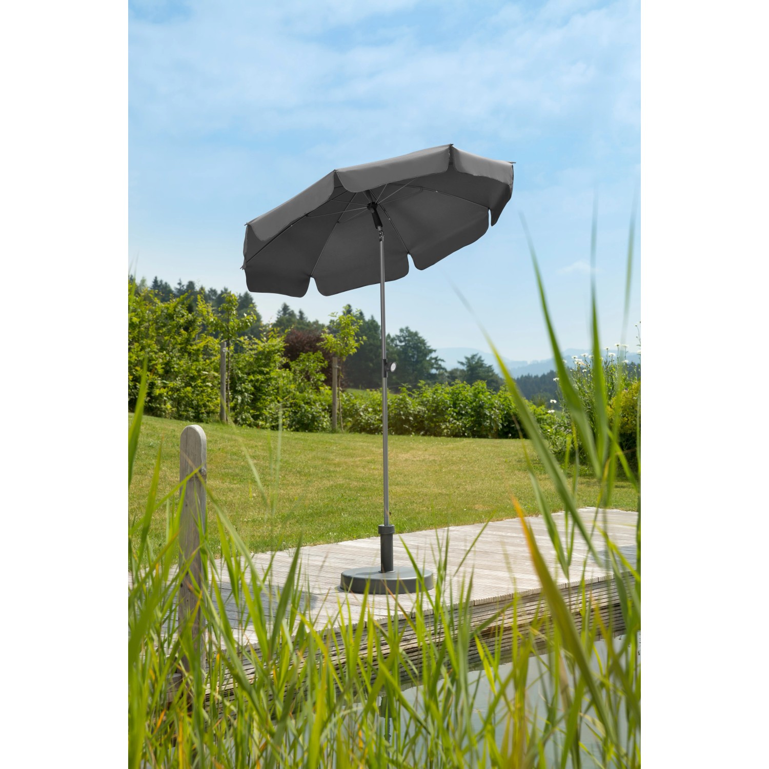 Anthrazitfarbener Schneider Balkonschirm Locarno Ø 150 cm mit Push-Up Mechanik im Garten.