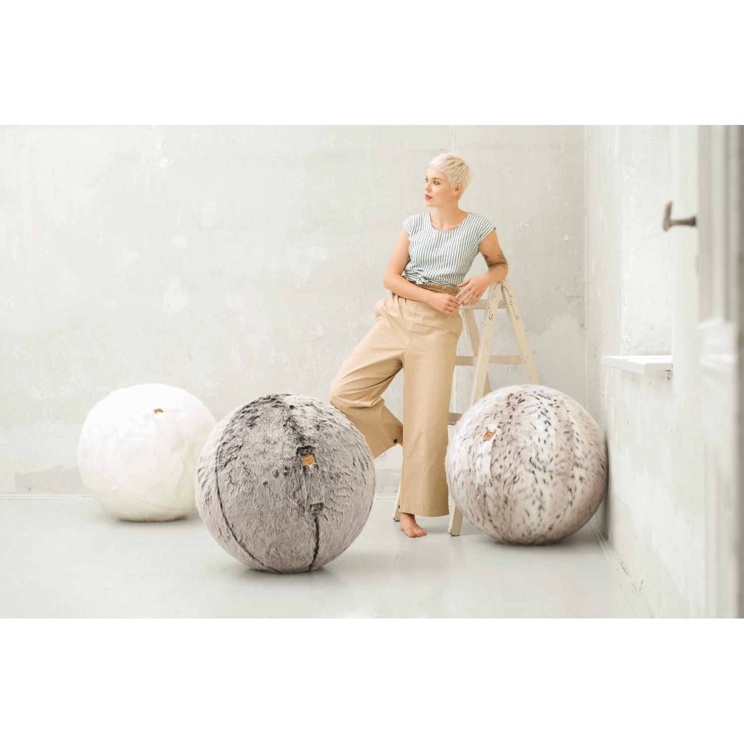 Sitting Ball Hocker Skins Schneeluchs, 3 Hocker in Weiß und Fellimitat-Muster.