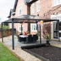 Palram Canopia Martinique Gartenpavillon 3.6 x 4.9 m in Anthrazit mit LED-Set und Tischgruppe.