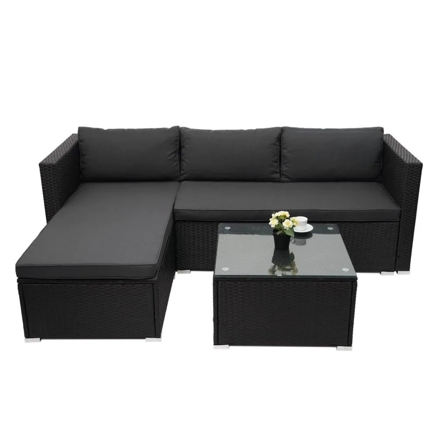 Schwarze Poly-Rattan Gartenmöbel Garnitur mit L-Sofa, dunkelgrauen Kissen und quadratischem Glastisch.
