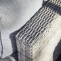 Detailaufnahme: Lounge-Sessel Olea aus Polyrattan in Sand mit hellgrauen Kissen.
