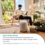 Gardena Smart Water Control Bewässerungscomputer auf Tisch, Mann mit Smartphone im Hintergrund.
