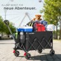 Faltbarer, schwarzer Tectake Bollerwagen Rollrider mit Gepäck und Teleskopgriff.