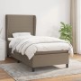 Taupes Boxspringbett 90x190 cm mit Matratze und hohem Kopfteil im Schlafzimmer.