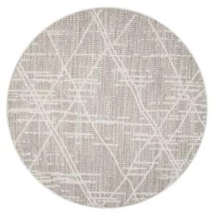 Runder, beiger Teppich Klassiko mit Fransen, 160x160 cm. Kurzflor mit geometrischem Muster.