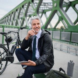 Mann mit E-Bike und verstellbarem Fahrradständer im Hintergrund.