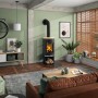 Justus Kaminofen Faro 2.0, Stahl schwarz/Sandstein beige, 6 kW im Wohnraum mit Holzscheiten.