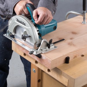 Makita Handkreissäge 65 mm im Einsatz beim Holzzuschnitt auf einer Werkbank.