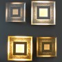 Vier quadratische LED-Wandleuchten Window in Gold und Silber, 32x32 cm.