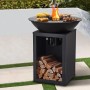 Schwarzer Vente-unique Grill Ignos 80 cm mit Plancha, Feuerschale und Holzfach im Garten. Ideal für BBQ.