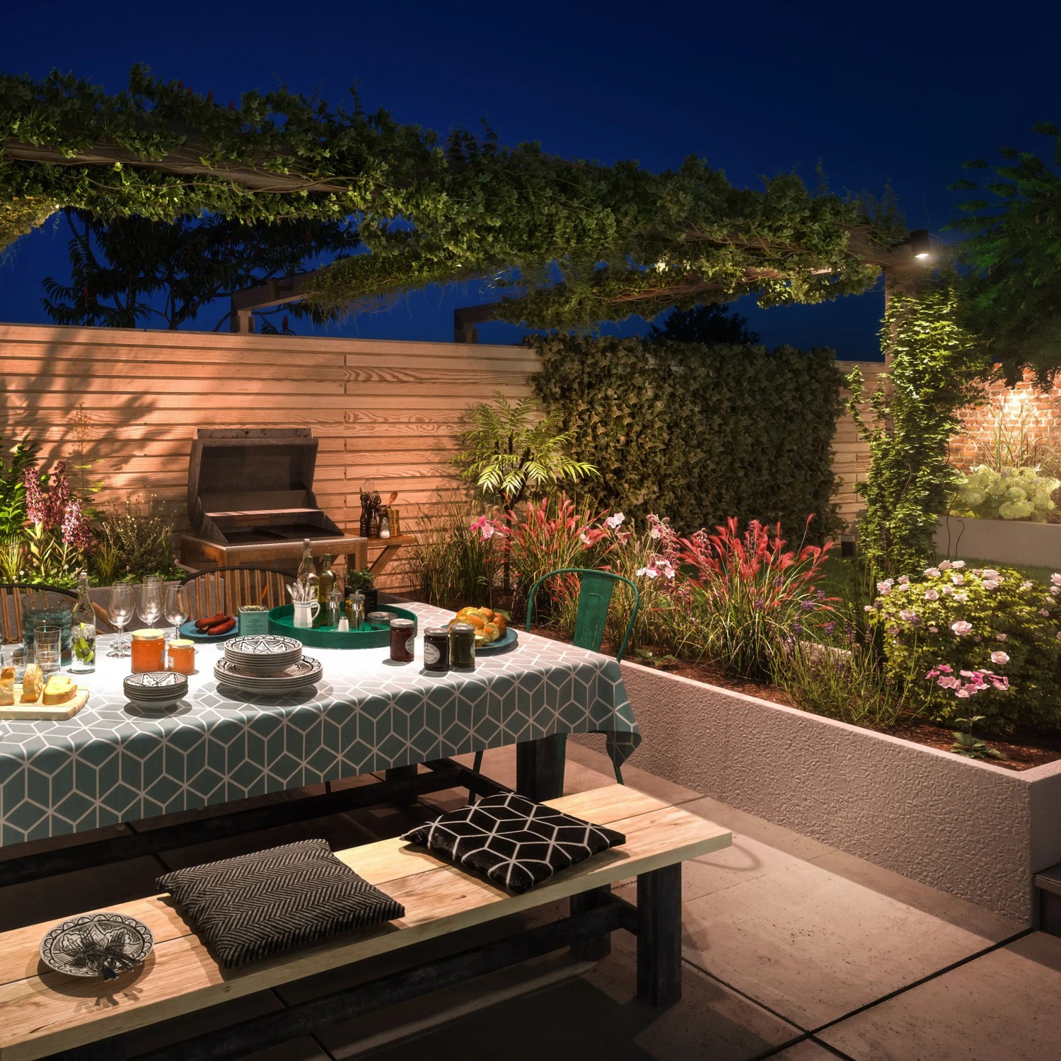 Beleuchteter Garten mit Philips Hue Lily Spots, Esstisch und Grill. Smarte Außenbeleuchtung für stimmungsvolle Abende.